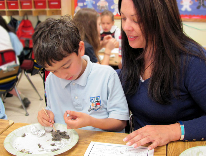 Student and teacher examining owl pellet